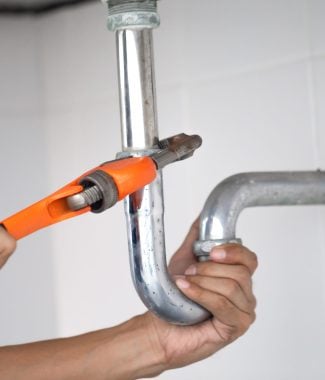 plumber at work in a bathroom, plumbing repair service, assemble and install concept.